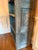 A wonderful antique primitive open cupboard featuring an exceptional timeworn blue painted finish and charming hand-cut...