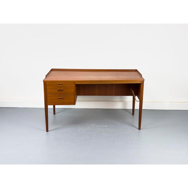 A rare, high-quality mid-century modern desk with an asymmetrical tabletop. The design is characterized by its clean and...