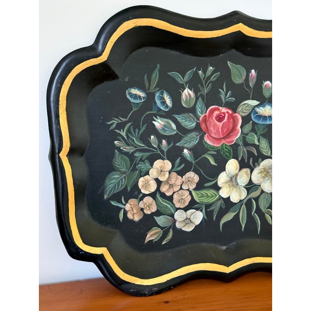 Black metal tole tray with hand-painted flowers and gold surround. Artist signed and dated on back. Please see condition...