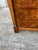 Striking French 19th-century Empire commode featuring richly figured burl walnut veneer, four drawers, and a dramatic dark...