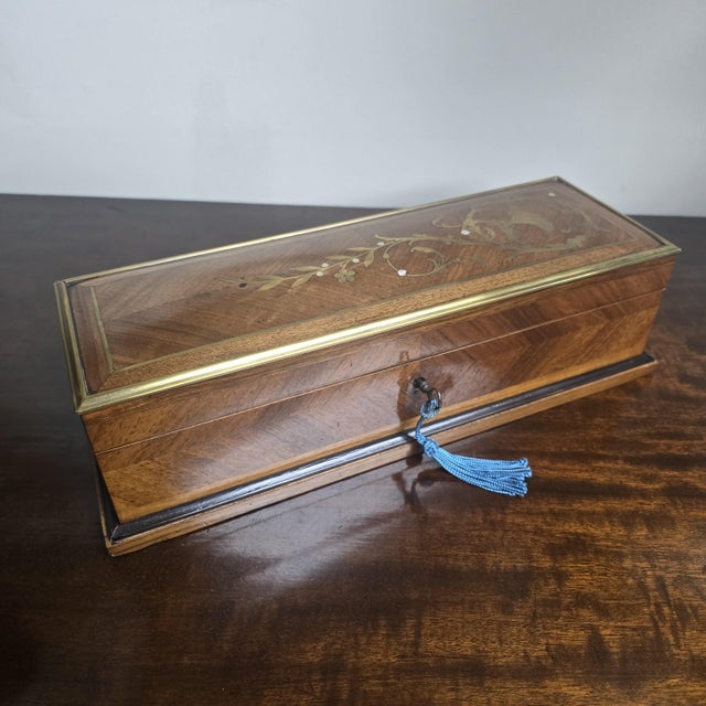 A superior French walnut and kingwood glove box with brass banding and brass inlay, ,super deep buttoned blue sating...