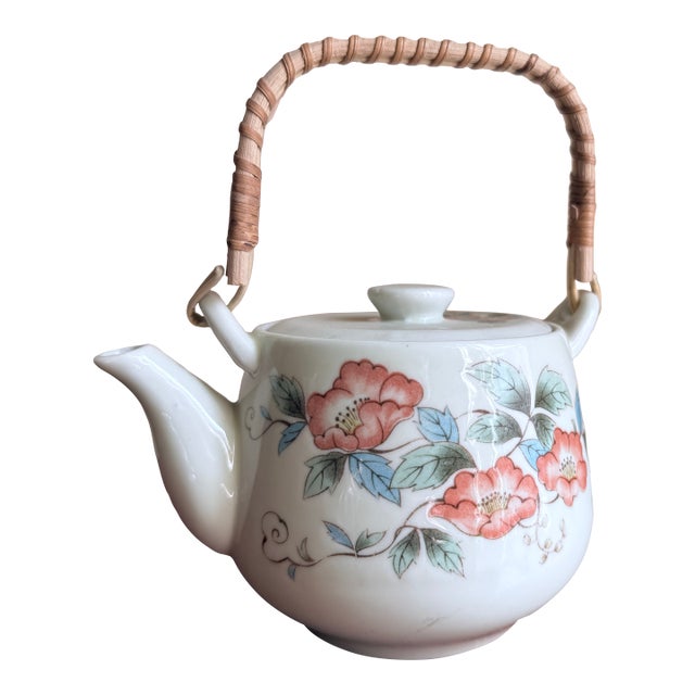 Mid-20th century Japanese porcelain tea set with hand-painted floral decoration and woven bamboo handle. White porcelain...