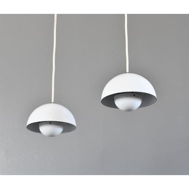 Pendant 'flowerpot' vp1 lights by verner panton circa 1960s - vitreous white enamel shades with orange enamel inner -...