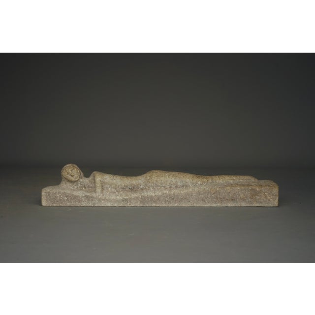 An unusual carved sculpture of a reclining nude.