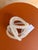 Contemporary decorative glass sculpture featuring an elegant interlocking knot design that adds sculptural interest to any...