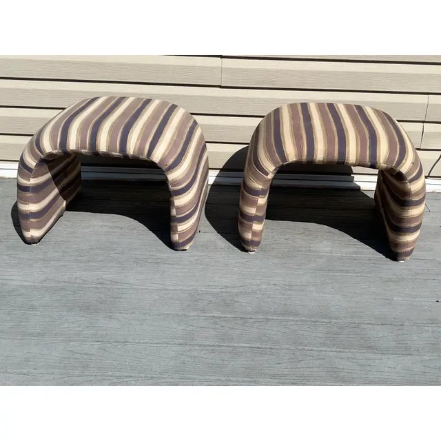 A pair of waterfall stools made by Weiman. The pair is wrapped in silky stripped fabrics and is in very good vintage...