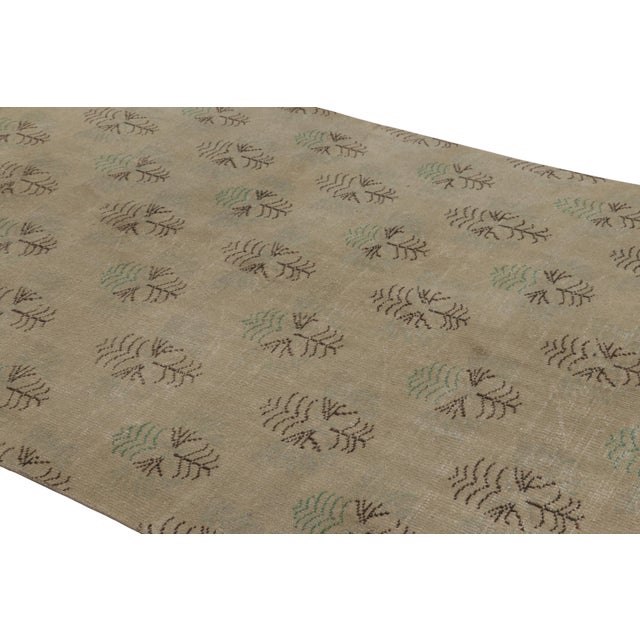 This vintage rug is a 6x9 Turkish distressed piece, made with hand-knotted wool circa mid-20th century. It is an exciting...