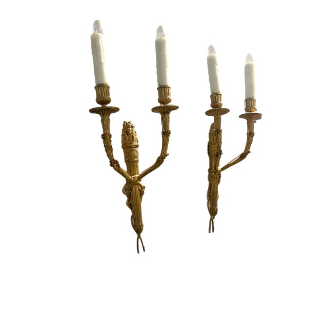 A wonderful set of four French dore bronze regency, neoclassical, Empire style torchiere two candelabra light sconces In...