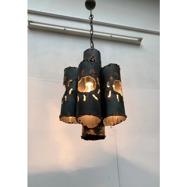 Heavy steel chandelier in brutalist design. The chandelier consists of steel tubes of different heights, arranged radially...