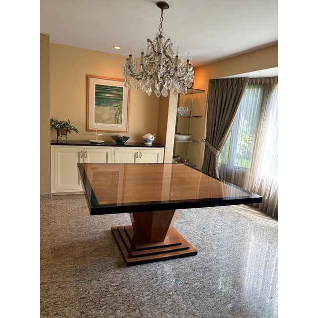 Elevate your dining space with this striking, architecturally inspired dining table. Featuring a generous 60-inch square...