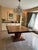 Elevate your dining space with this striking, architecturally inspired dining table. Featuring a generous 60-inch square...