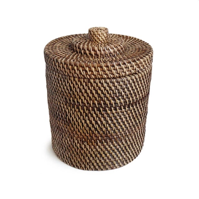 Vintage hand woven tea stain finish rattan basket with lid. Attractive piece with many uses. Each slightly unique in...