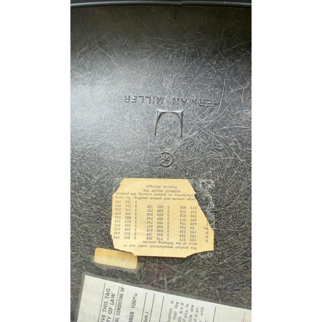 An authentic Herman Miller Eames upholstered fiberglass shell side chair retaining its original manufacturer labels and...