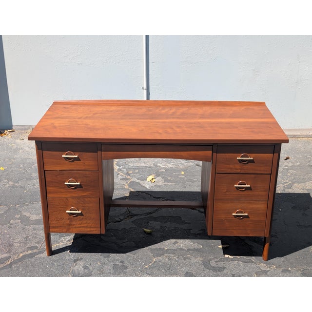 Beautiful Mid-Century Modern walnut desk by Lane, circa 1960s, featuring a warm walnut finish, elegant brass pulls, and a...