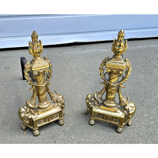 A stunning Pair of Antique French Neoclassical Cast Brass Andirons, Circa 1920s Measures 7" in width fully open, 14" in...