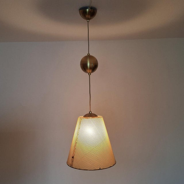 Original pendant lamp from the renowned german manufacturer erco, dating from the 1950s/60s. The lamp impresses with its...