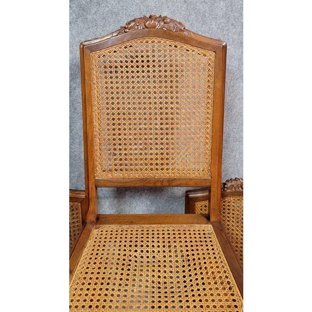 Set of 6 Art Deco walnut chairs, circa 1925 Cane-bottomed seats and backs (1 relaxed seat) Carved decorations on the upper...