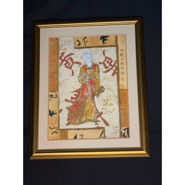 Decorative Asian-inspired framed artwork featuring a traditional figure with calligraphy-style background details and warm...