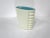 A very nicely designed smooth creamy white glaze with side ribbing to the form and a turquoise interior . The tapered vase...