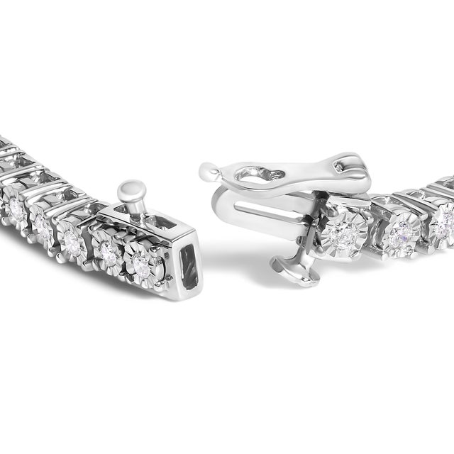 Elegant and timeless, this gorgeous pure 92.5% sterling silver tennis bracelet features 1/2 carat total weight of round...