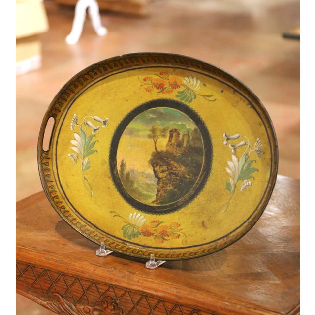 Decorate a cocktail table or ottoman with this charming antique painted tray. Crafted in France circa 1870, the oval tôle...