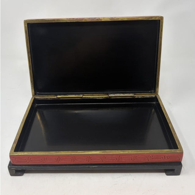 Vintage Chinese carved cinnabar lacquered box. The lid showcases an intricately detailed relief landscape with cranes,...