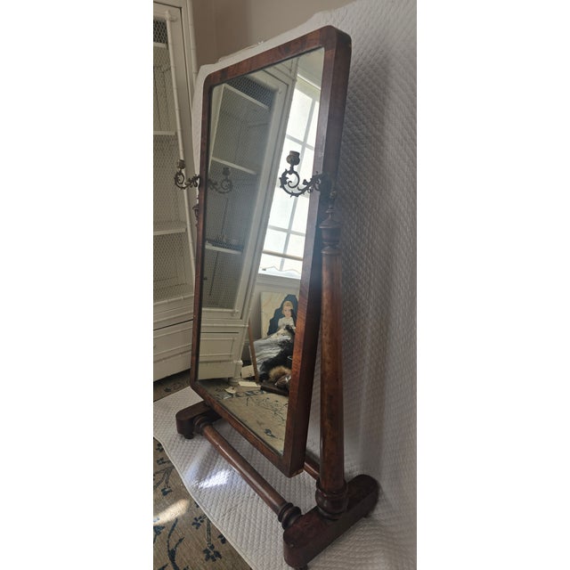 A finely proportioned 19th century cheval floor mirror featuring a rectangular plate set within a solid wood frame,...