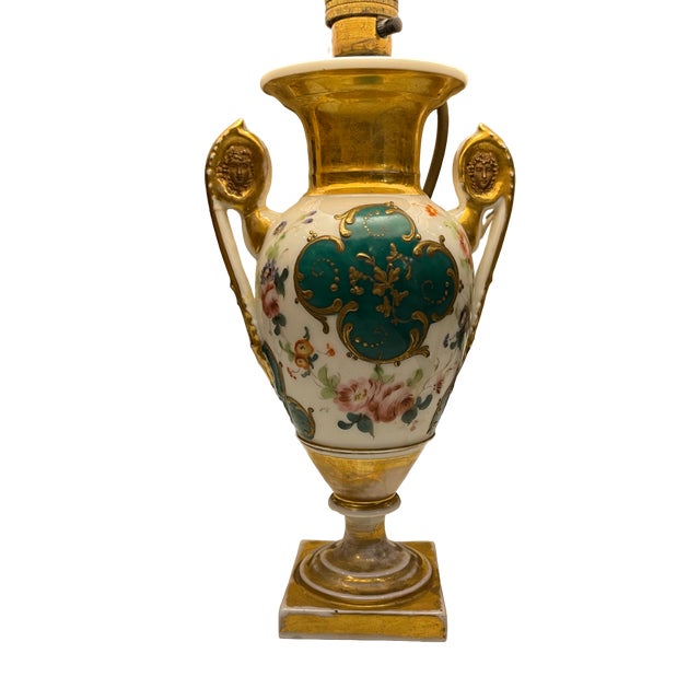 Small table lamp with a porcelain vase-shaped base decorated in white and green tones, with floral details and gold...