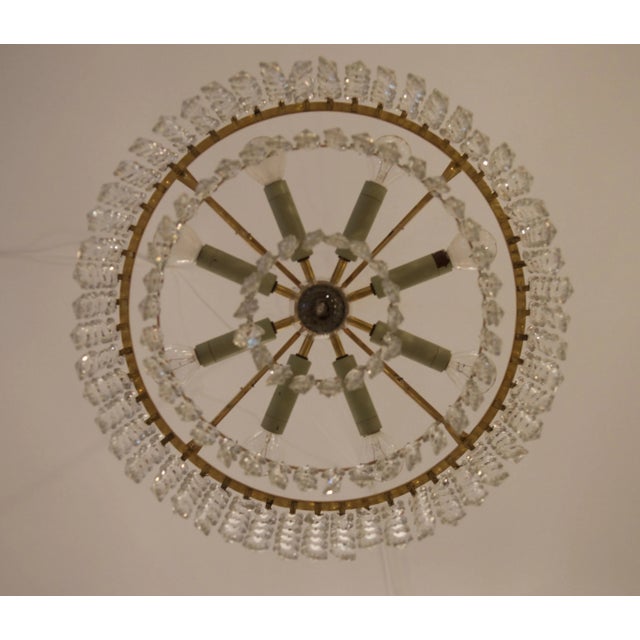 This chandelier was designed during the 1950s and manufactured by J.L. Lobmeyr in Vienna. It features a signed brass frame...