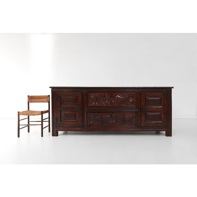 A remarkable early French oak sideboard dating to around 1550, displaying the quiet power, authenticity, and time‑worn...