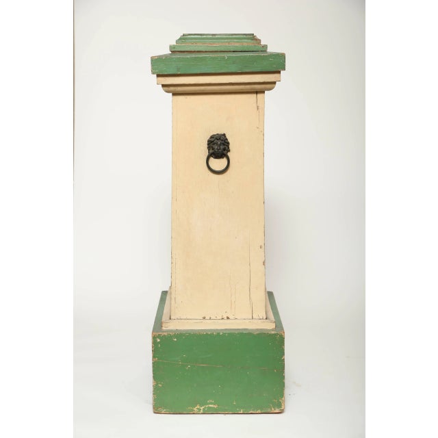Hand-painted wood pedestal with lion's head handles from a conservatory. Original green and cream painted decoration....