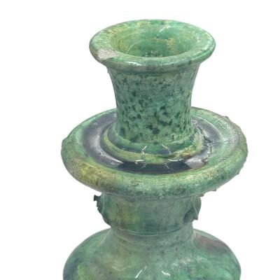 A Moroccan Tamegroute glazed candlestick holder is a handcrafted piece made in the historic pottery village of Tamegroute...