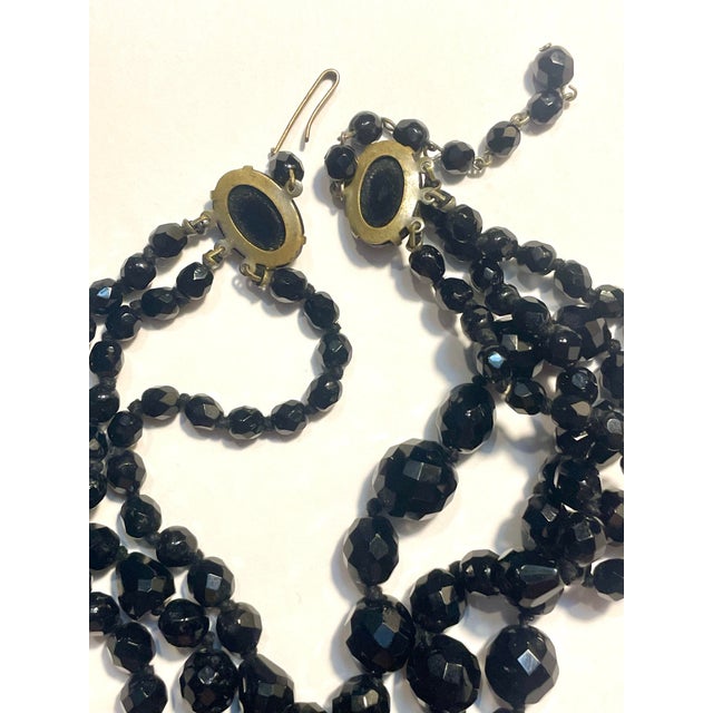 West German mid-century statement necklace features a three-strand graduated construction crafted from faceted black jet...