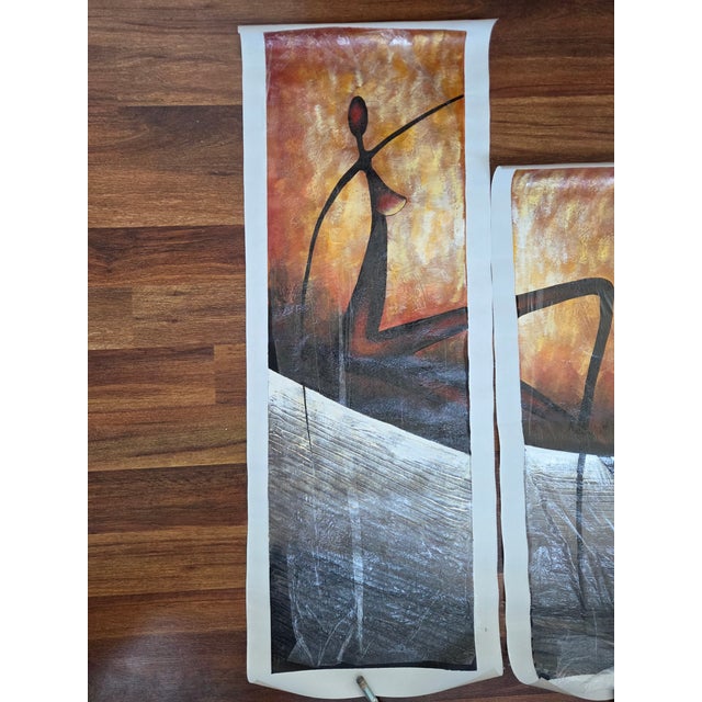 This four-panel hand-painted tetratych presents movement in its purest form—elongated tribal figures sweeping across a...