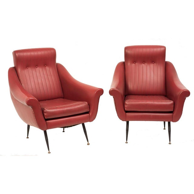Pair of armchairs with padding upholstered with skai, structure in painted metal and extremities in brass.