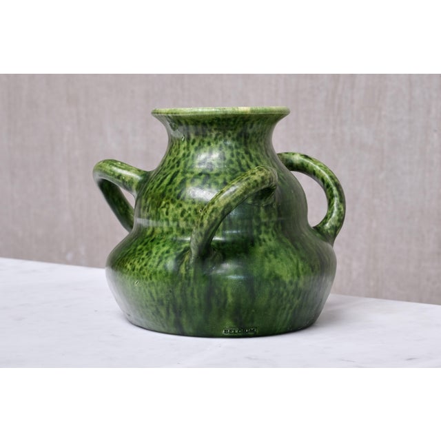This Art Nouveau vase was produced in Belgium circa 1910. It bears an impressed BELGIUM mark on the lower body, a...