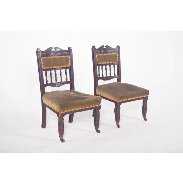 Pair of old ladies' chairs. with a seat and back upholstered in green velvet, the backrest is made up of a central...