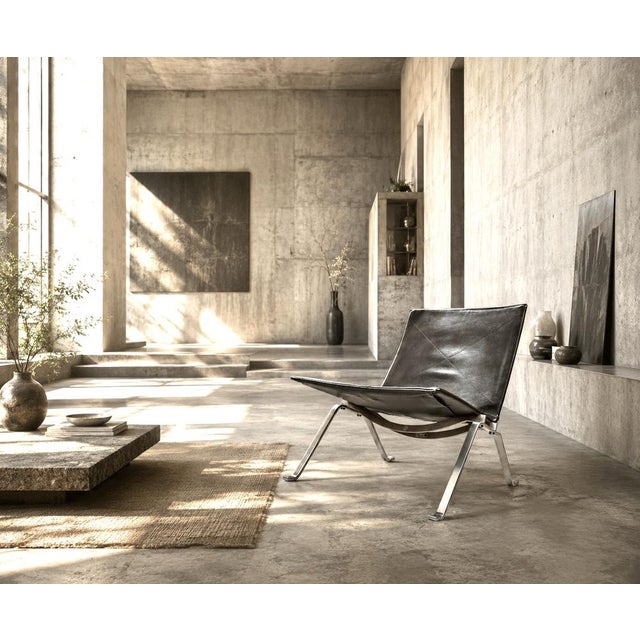 Danish lounge chair designed by poul kjærholm and produced by fritz hansen. executed with a black leather seat mounted on...