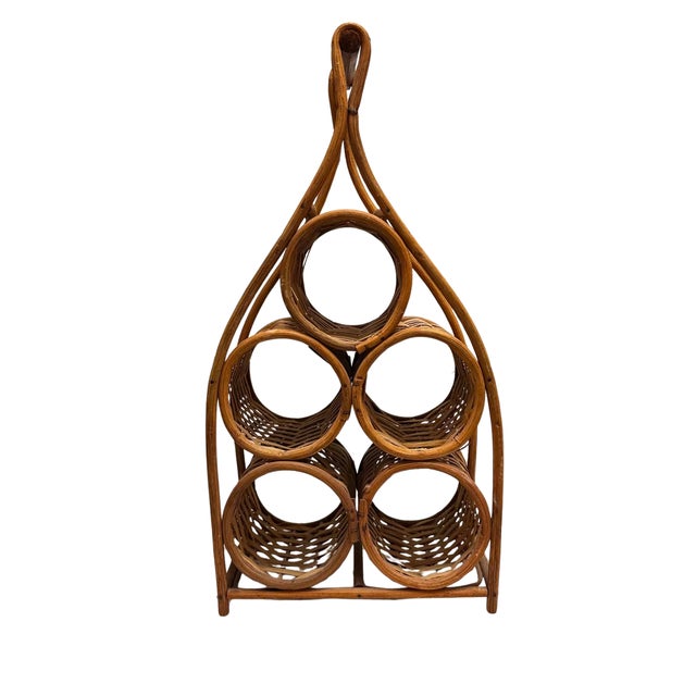 A sculptural vintage wine bottle holder crafted from bent rattan and woven cane, designed to accommodate six bottles in...