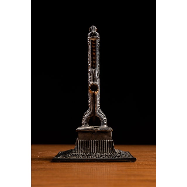 Early tabletop cigar cutter constructed of cast iron. 5.5"W x 4.5"D x 8.5"H. This unique cigar cutter also doubles as a...