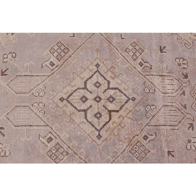 A majestic example of Anatolian weaving artistry, this oversized antique Turkish Oushak rug embodies the enduring charm...