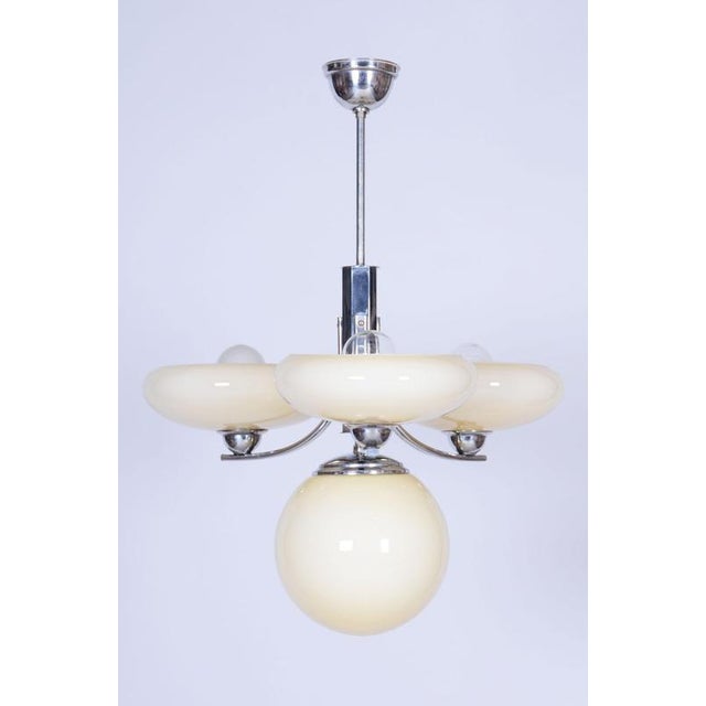 This unique chandelier, created in Czechoslovakia during the 1920s, carries the unmistakable signature of the transitional...