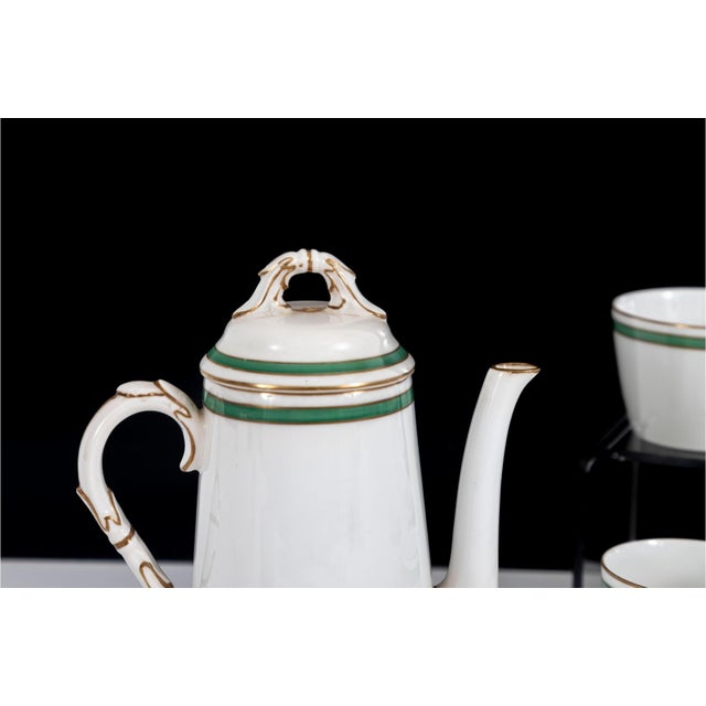 An elegant, early 20th-century antique fine porcelain tea and coffee service by the illustrious Royal Worcester of...