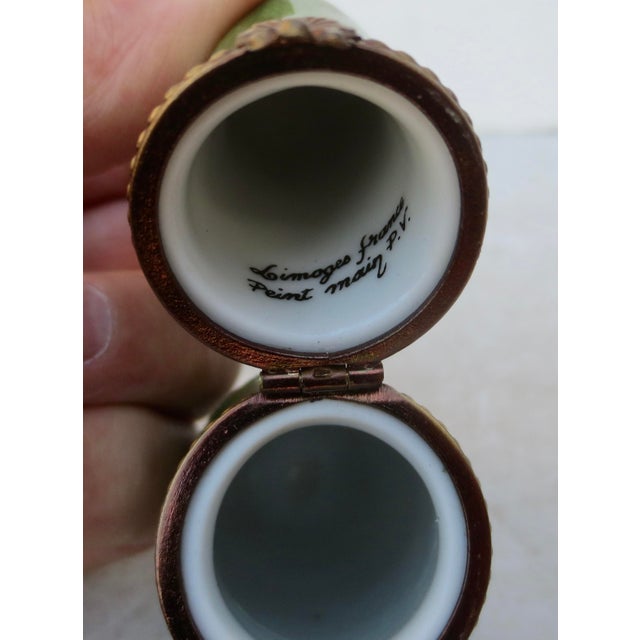This item is a hand-painted Eximious Limoges, France porcelain trinket box. A zucchini porcelain pill box, part of a...