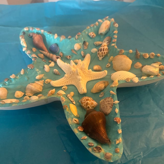 Bring a touch of coastal charm into your home with this beautiful starfish-shaped decorative wooden dish. The piece...