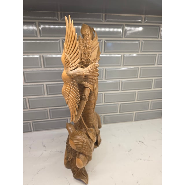 An extraordinary, investment-grade mid-century Balinese wood carving depicting Dewi Sri, the Goddess of Rice, Agriculture,...
