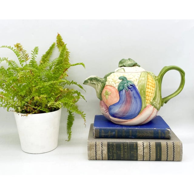 Charming, vegetable garden patterned Fitz and Floyd teapot. Maker's mark and 1986 on the underside. Holds 1.25 quarts/ 5...