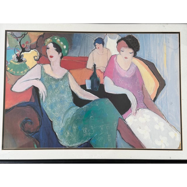 Vintage framed art print titled “In the Lounge” by listed Israeli artist Itzchak Tarkay (1935–2012), known for his elegant...