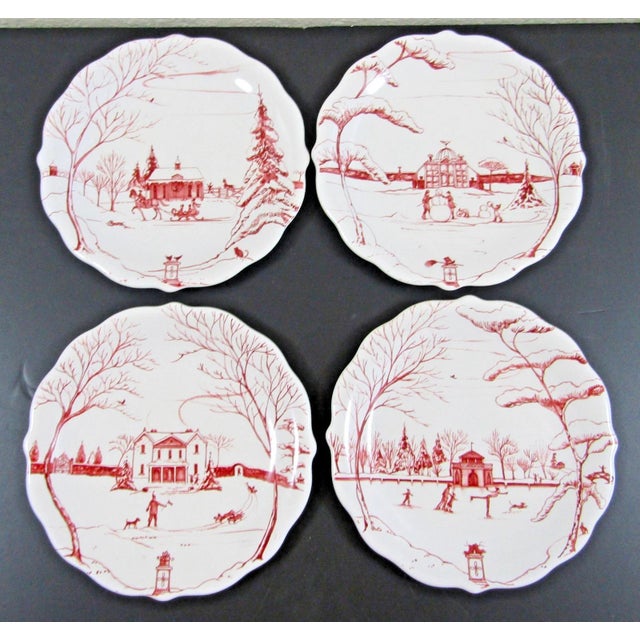 The Juliska Country Estate Ruby Party Plates are a set of four round ceramic plates featuring assorted landscape designs...
