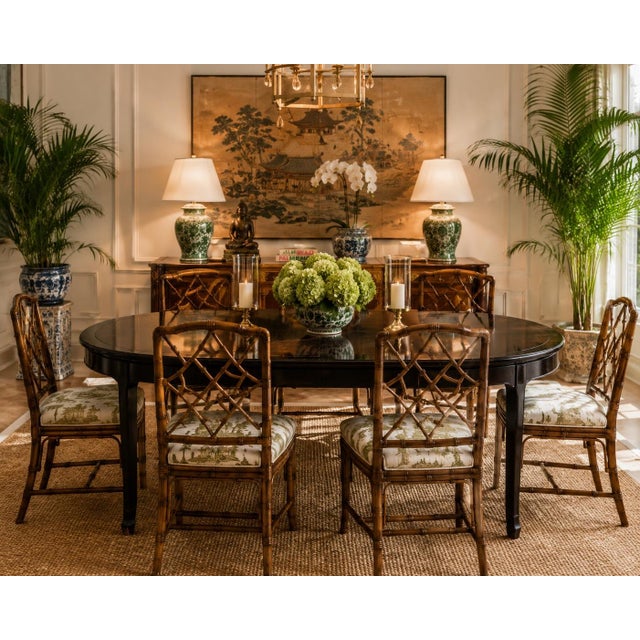 Elegant vintage Asian-inspired dining table featuring a rich black lacquered wood frame with contrasting warm wood-grain...